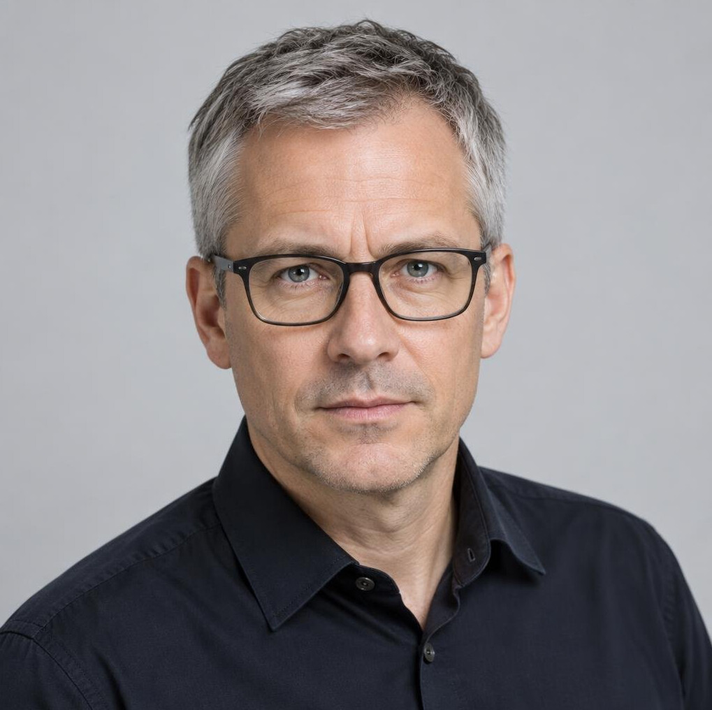 Studio portrait of a Swiss man journalist with glasses